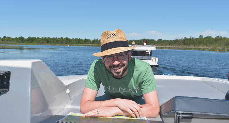 Man with hat on boat